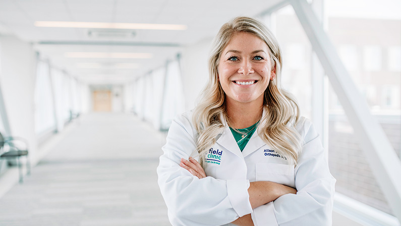 Woman smiling in a well lit walkway.