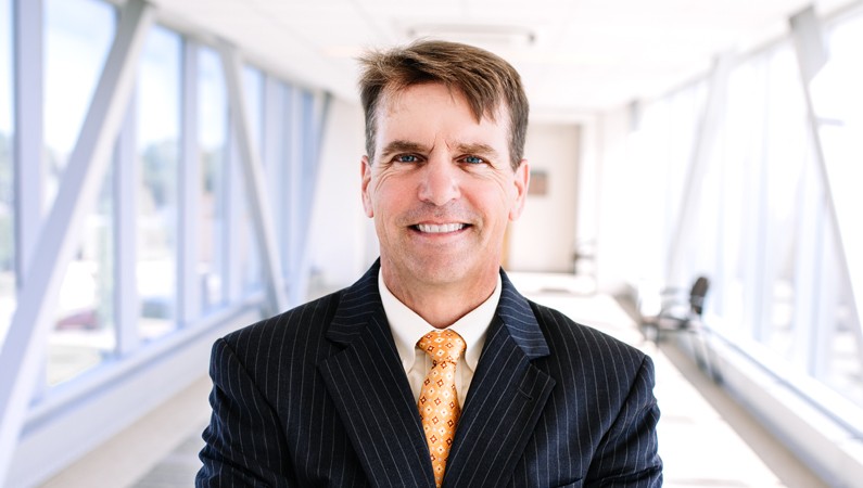 Man smiling in a well lit walkway