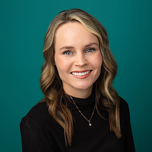 Female physician assistant smiling in professional headshot.