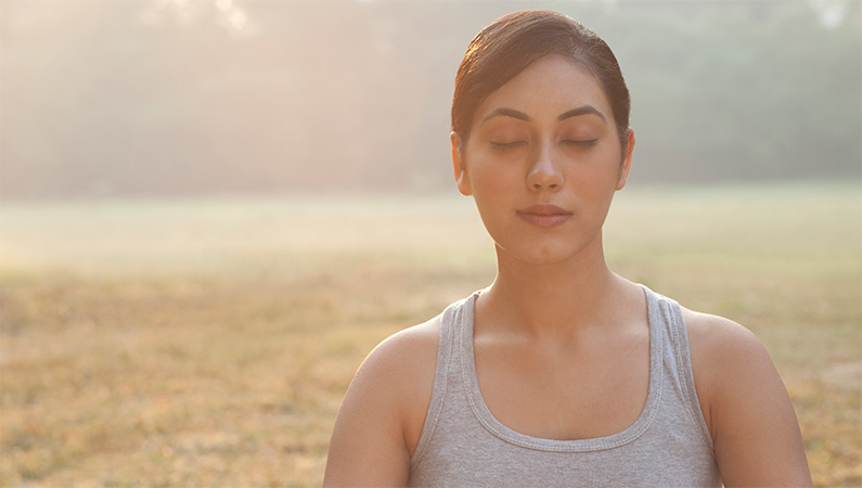 Woman meditating outside,