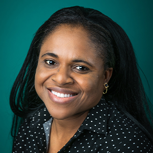 Female nurse practitioner smiling in professional headshot.