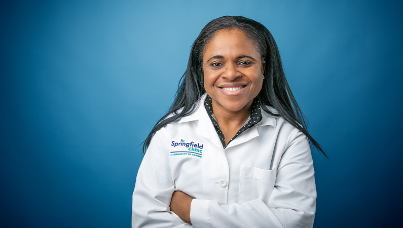 Female nurse practitioner smiling in professional headshot.