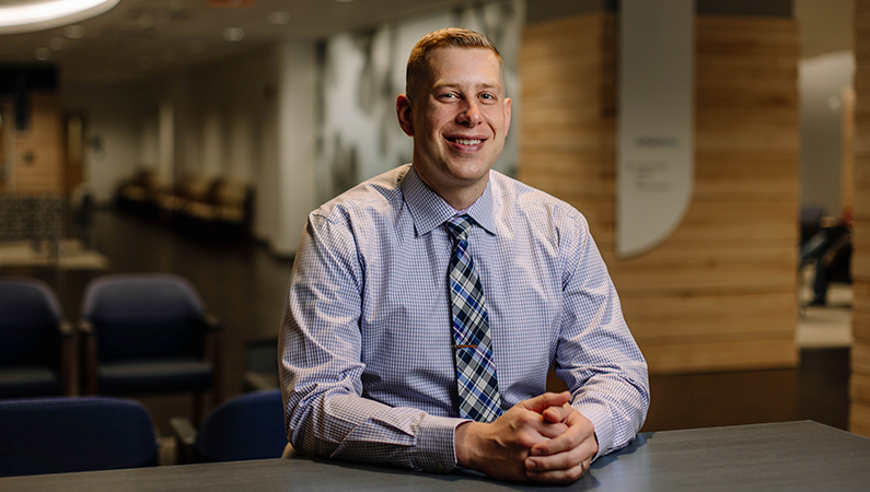 Male orthopedics doctor smiling in a café setting.