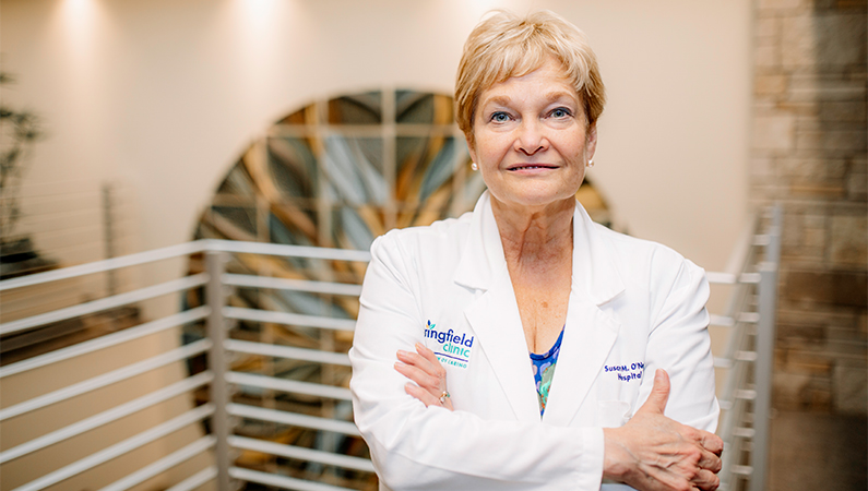 Female doctor of osteopathic medicine posing with arms crossed.