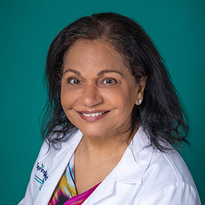 Professional headshot of female doctor in white coat.