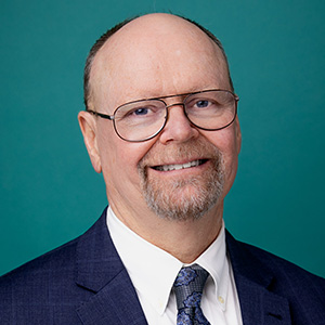 Male doctor smiling in a professional headshot.