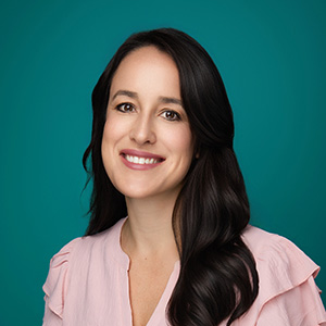 Female nurse practitioner smiling in professional headshot