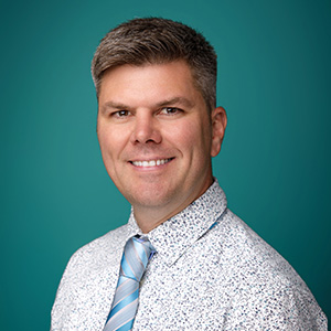 Male nurse practitioner professional headshot.