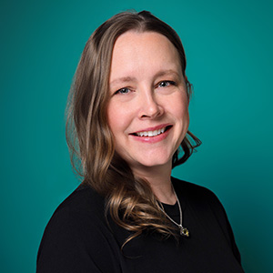 Female nurse practitioner smiling in professional headshot