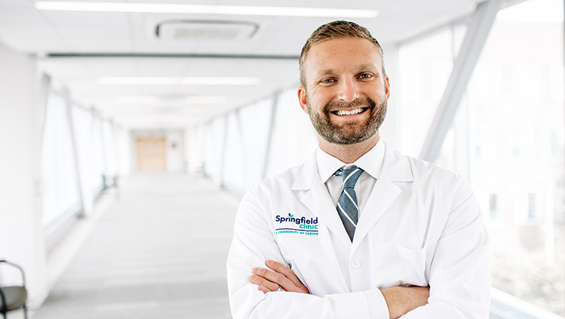 Man smiling in a well lit walkway.