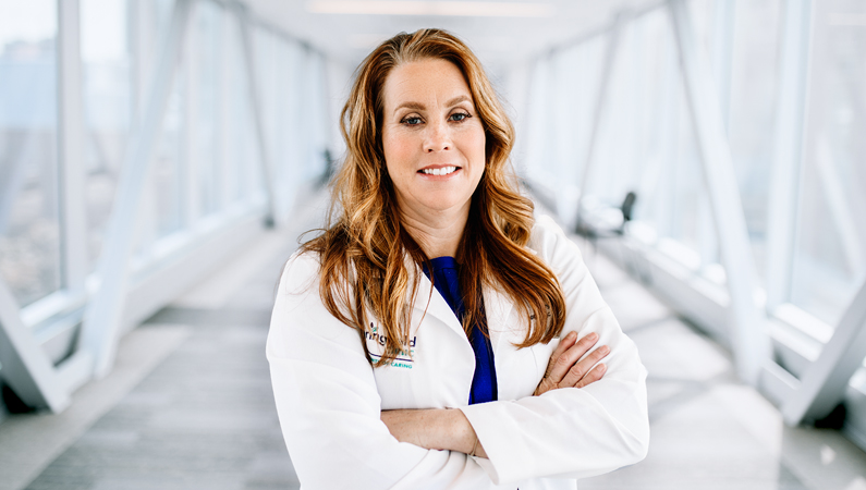 Woman smiling in a well lit walkway.