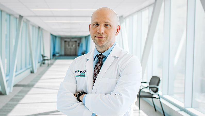 Man smiling in a well lit walkway.