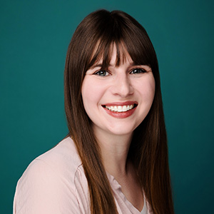 Female family medicine physician smiling in professional headshot.
