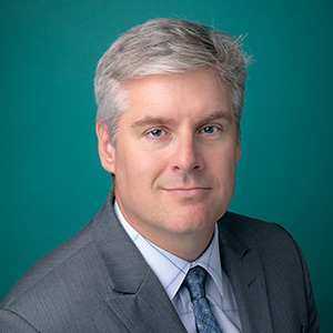 Male doctor smiling for professional headshot.