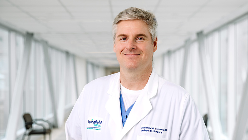 Male orthopedic doctor's professional headshot.