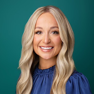 Female nurse practitioner smiling in professional headshot