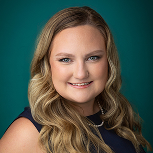 Female nurse practitioner smiling in professional headshot