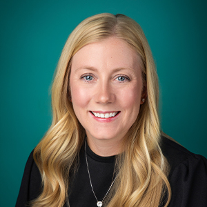 Female nurse practitioner smiling in professional headshot