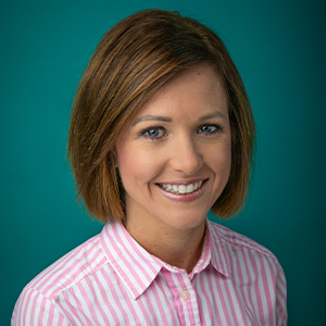 Nurse practitioner smiling in professional headshot.