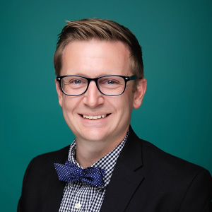 Male cardiologist smiling in professional headshot.
