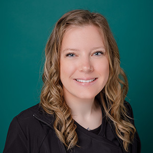 Female licensed massage therapist professional headshot.