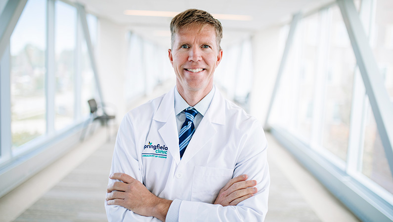 Man smiling in a well lit walkway.
